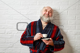 Happy Senior Man with Beard Drinking Coffee