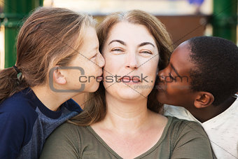 Sons kissing their mother