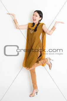 Excited Indian Chinese woman showing something
