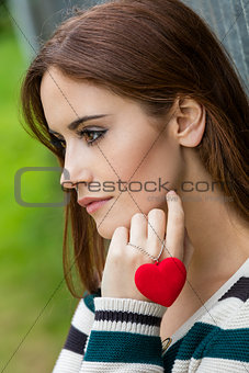 Sad Thoughtful Woman With Red Heart Necklace
