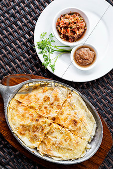 mexican cheese quesadilla with salsa and chilli sauce