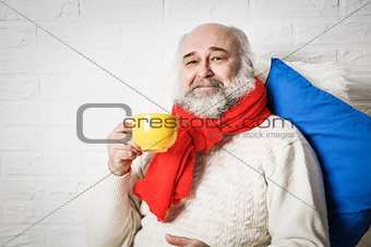 Senior Man with Beard Drinking Tea in Winter