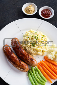 german sausage with mashed potato and vegetables meal
