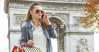 modern woman shopper in Paris, France using smartphone shopper