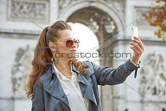 fashion-monger in Paris, France taking selfie with phone