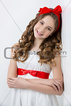 Teen girl with red bow on head