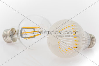 two LED bulbs with different cover, plastic and glass