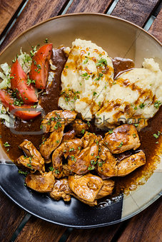 chicken breast with brown gravy sauce and mashed potato