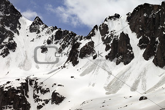 Snow rocks with traces from avalanche in sun spring day