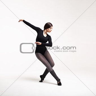 young woman dancer in black swimsuit posing