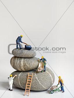 Pebbles stack and figurines of construction 