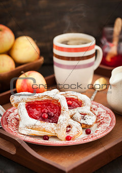 Delicious berry puff pastry with powdered sugar and coffee