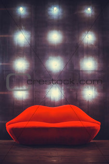 Beautiful luxury red lips sofa on grey background with lights