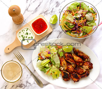 Chicken wings with salad