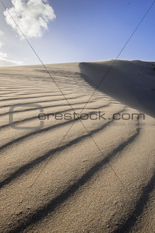 Wind blowing sand over dune
