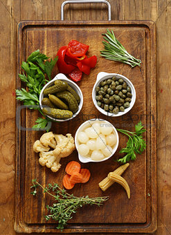 Assorted pickled vegetables (onions, capers, peppers, cucumbers)