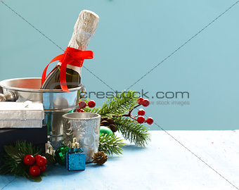 Christmas still life. Champagne, Christmas decorations and gifts.