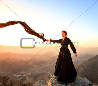 Woman with a scarf in the mountains