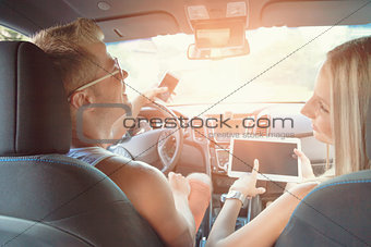 Young people enjoying a roadtrip in the car