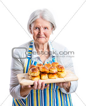 Senior woman holding fresh buns
