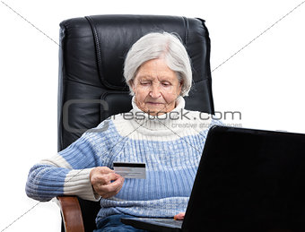Senior woman shopping online and paying with a credit card