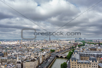 Eiffel tower over Paris, cloudy day