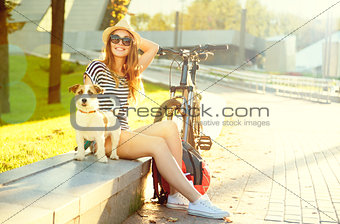 Happy Hipster Girl with her Pet in Summer Park