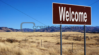 Welcome brown road sign