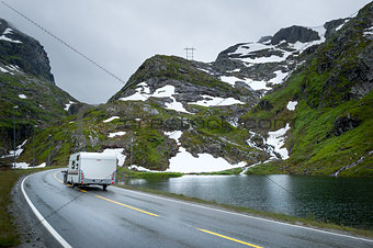 Camper traveling at scenic norwegian road in the mountains.