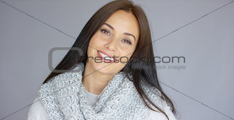 Gorgeous brunette woman posing isolated on gray background
