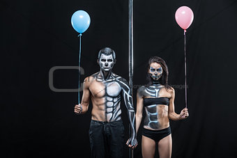 Couple of dancers with body-art and balloons