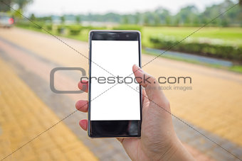 Right hand holds mobile phone with black white background