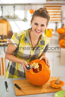 housewife prepare big orange pumpkin for Halloween party