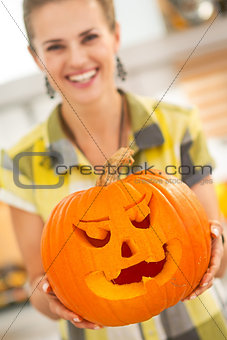 Closeup on housewife showing big pumpkin Jack-O-Lantern