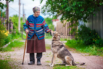 Elderly woman with a dog in countryside