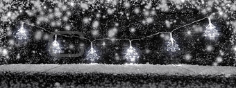 Christmas decoration lights with snow and copy space