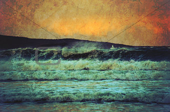 Grunge seascape of rough waves at sunset