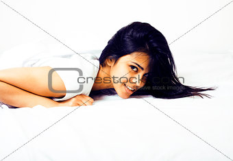 young pretty tann woman in bed among white sheets having fun, tr