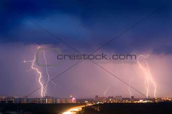 Lightning strike over city in purple light