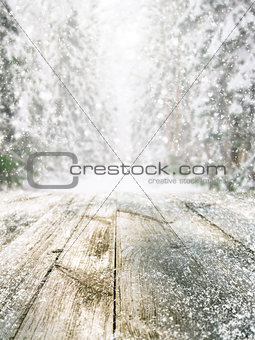 Wooden table in winter forest