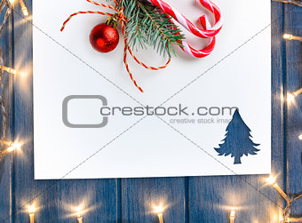 cut paper with lights in fir-tree shape on table