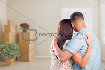 Military Couple Facing Empty Room with Packed Moving and Potted 