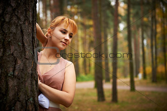 Pretty girl in autumn forest.