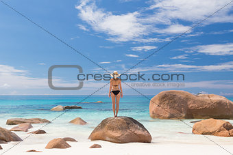 Woman enjoying Anse Lazio picture perfect beach on Praslin Island, Seychelles.