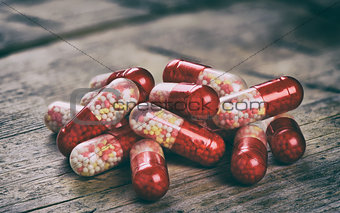 red capsules on wood table