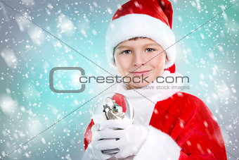 boy dressed up as Santa in winter setting