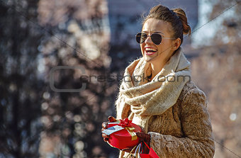 smiling traveller woman in Milan, Italy looking into distance