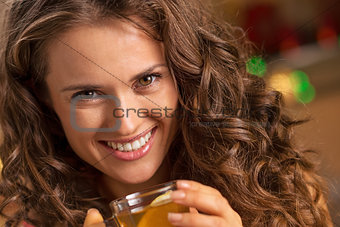 happy young woman with cup of ginger tea