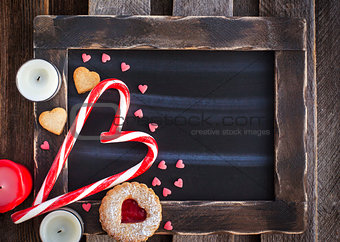 Chalk board and heart shaped candies and cookies