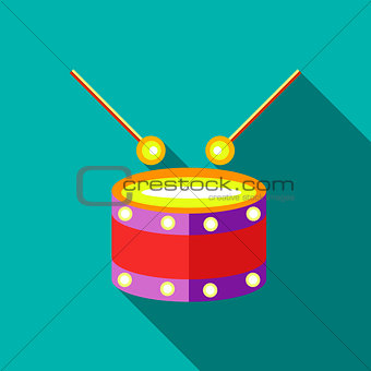 Children's toy drum on blue-green background